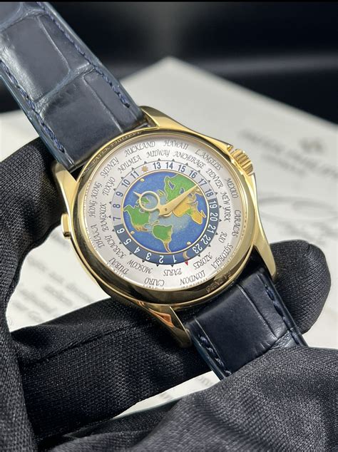 Patek Philippe 5131J World Time in Yellow Gold on Green.